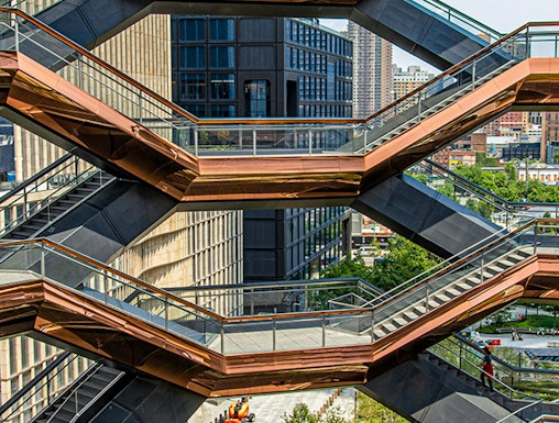 Vessel structure in New York with people walking on interconnected staircases.