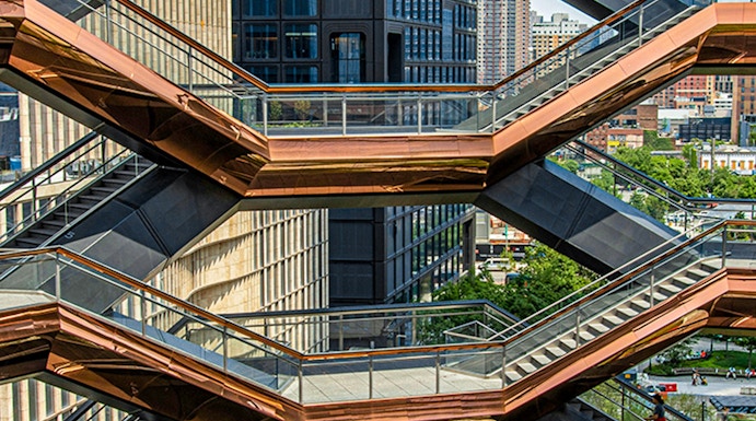 Vessel structure in New York with people walking on interconnected staircases.