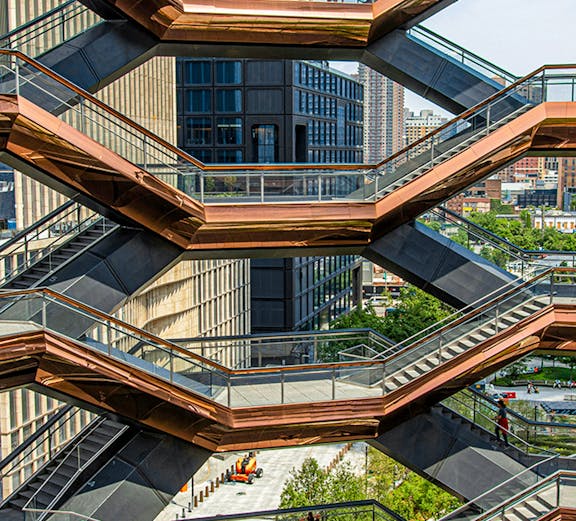 Vessel structure in New York with people walking on interconnected staircases.