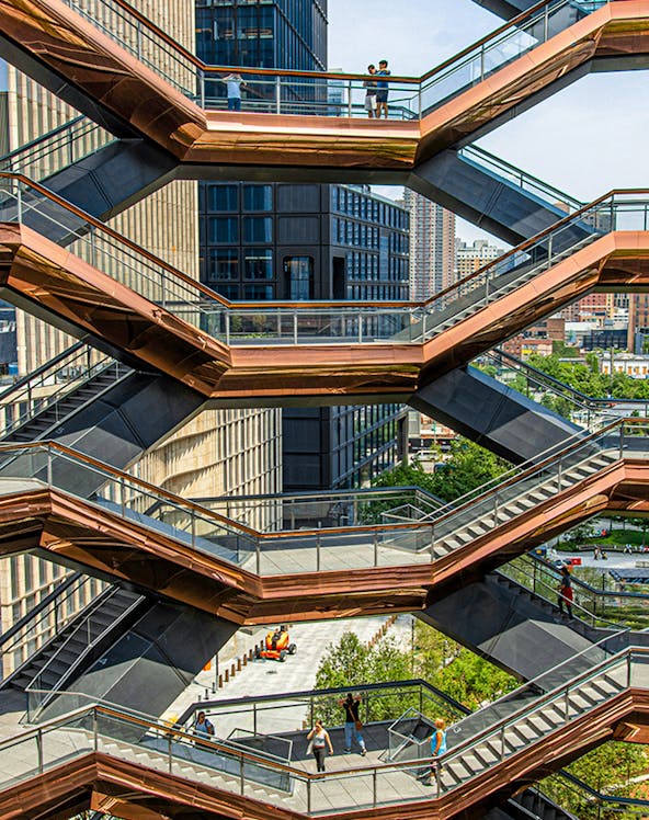 Vessel structure in New York with people walking on interconnected staircases.