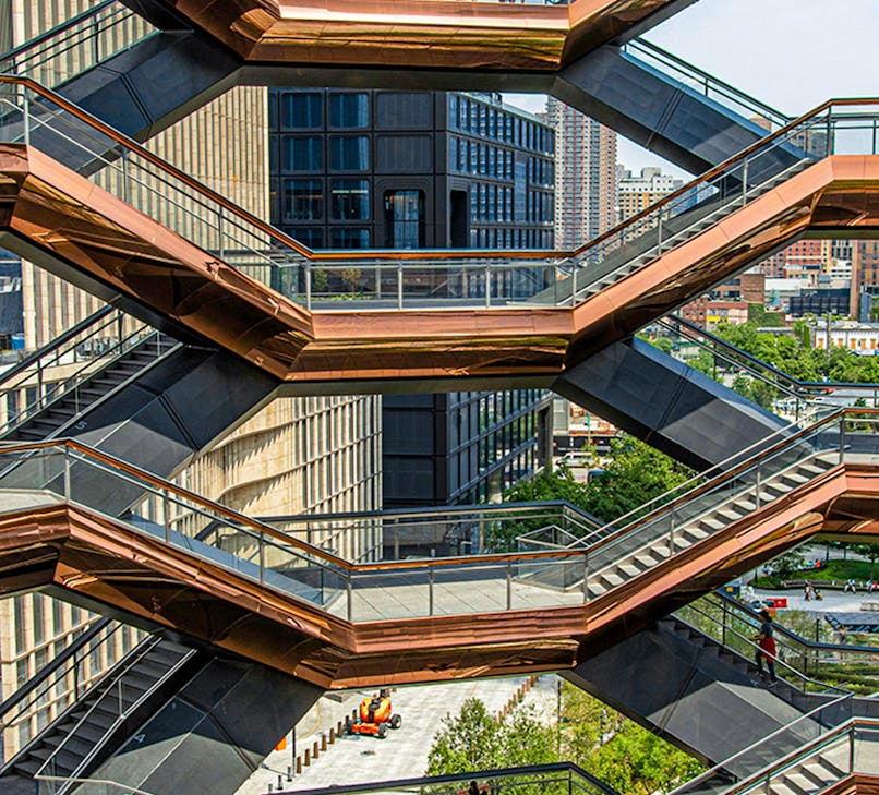 Vessel structure in New York's Hudson Yards with visitors exploring the interconnected staircases.