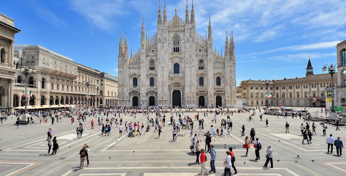Milan Duomo with tourists in Piazza del Duomo on a sunny day.