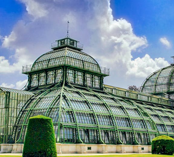 Glass-domed structure with green metal framework near St. Anne's Church, surrounded by manicured lawns.