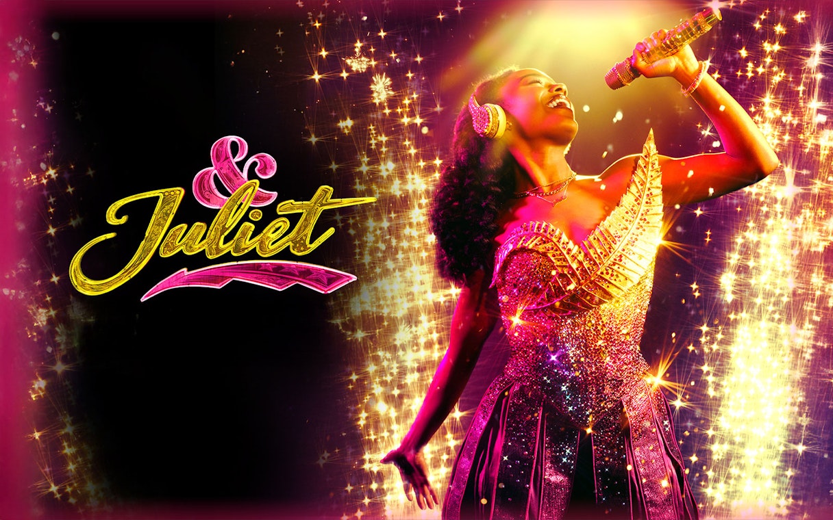 Performer singing on stage with "& Juliet" logo in sparkling lights.