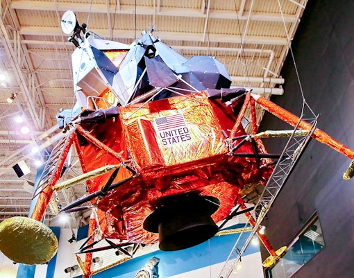 Lunar Module LTA-8 exhibit at Houston Space Center with detailed interior view.