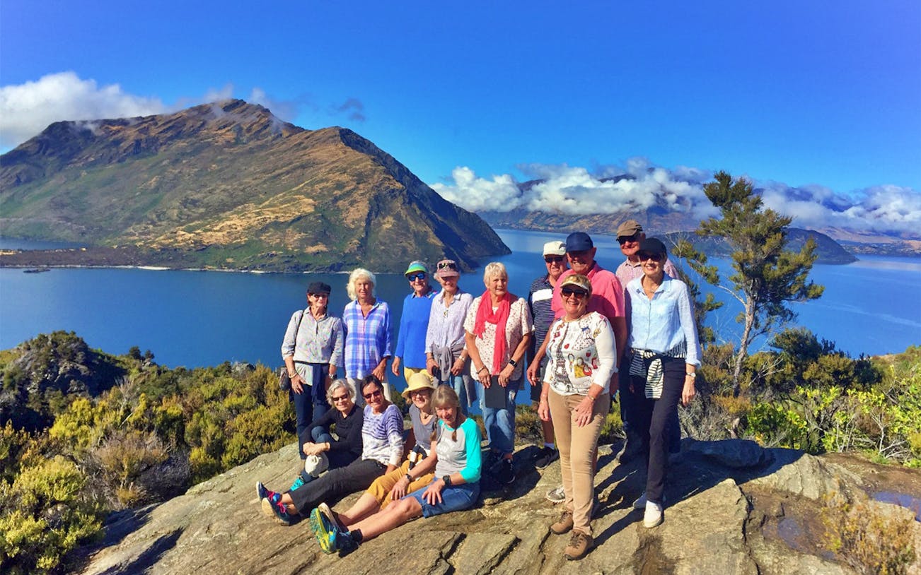 Group enjoying scenic view on Mou Waho Island during a guided nature walk and cruise.