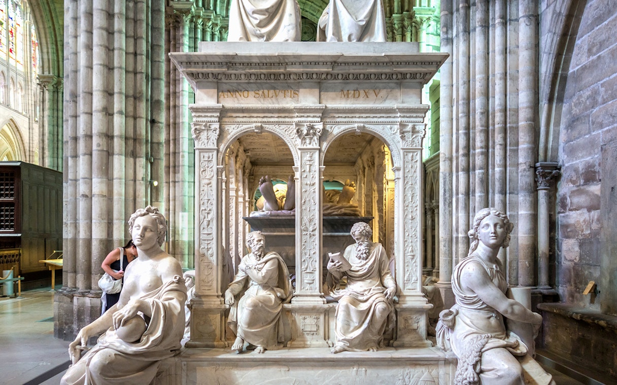 Sculptures inside Saint-Denis Basilica, Paris, showcasing intricate stone carvings.