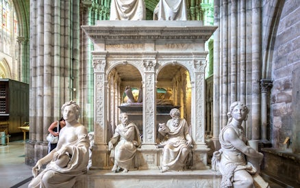Sculptures inside Saint-Denis Basilica, Paris, showcasing intricate stone carvings.