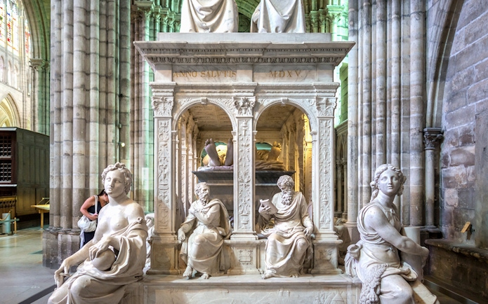 Sculptures inside Saint-Denis Basilica, Paris, showcasing intricate stone carvings.