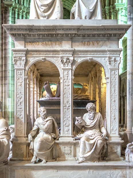 Sculptures inside Saint-Denis Basilica, Paris, showcasing intricate stone carvings.