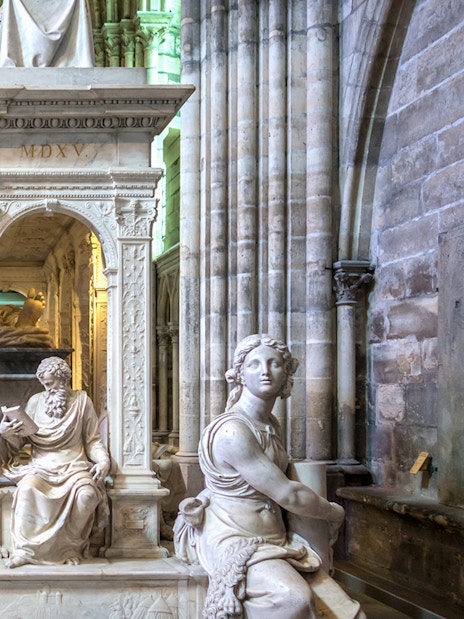 Sculptures inside Saint-Denis Basilica, Paris, showcasing intricate stone carvings.