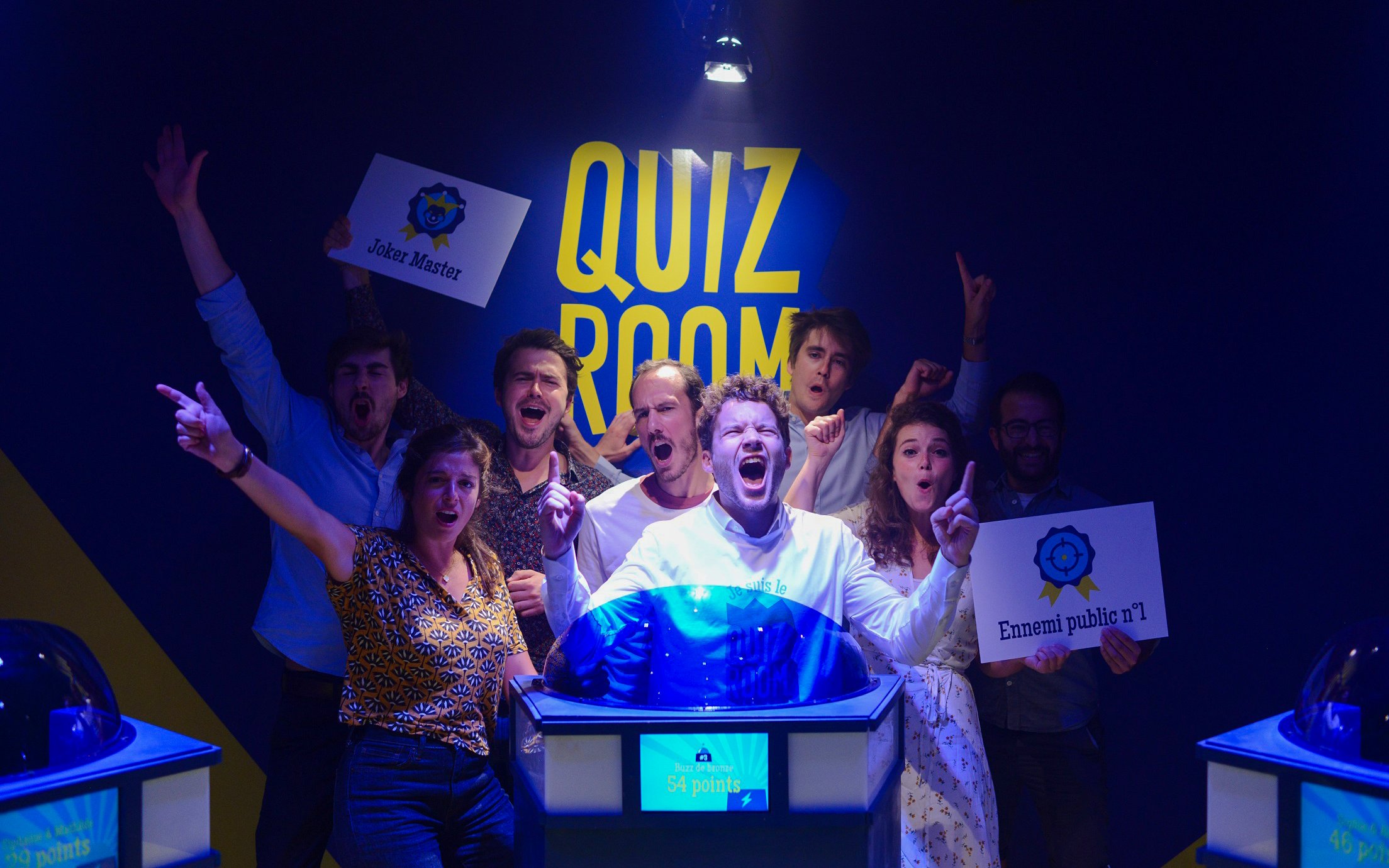 Participants excitedly engaging in Quiz Room game show experience, Dubai.