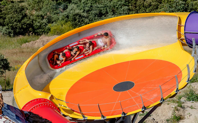 Visitors on a water slide at Aquopolis Villanueva de la Cañada.