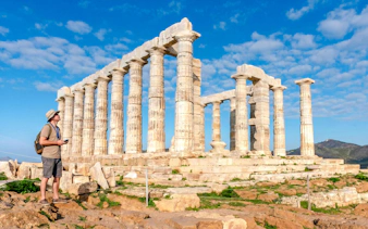 Guest using audio guide at Poseidon Temple, Cape Sounio.