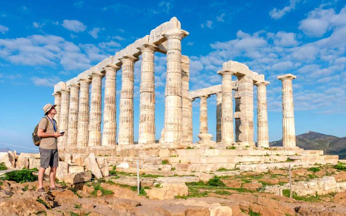 Guest using audio guide at Poseidon Temple, Cape Sounio.