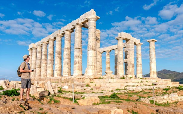 Guest using audio guide at Poseidon Temple, Cape Sounio.