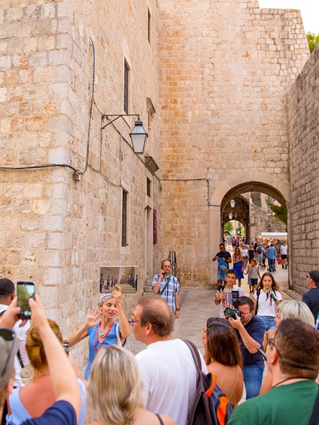 Guests exploring historic stone walls at Elaphiti Islands.