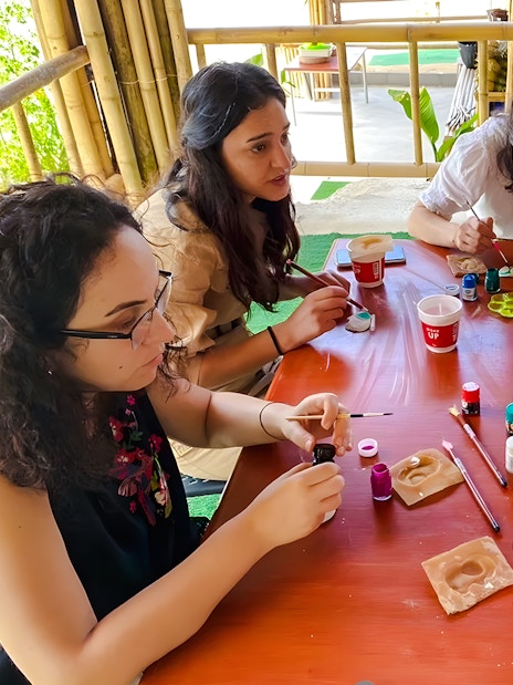 Group painting elephant miniatures at Phuket Elephant Care workshop.