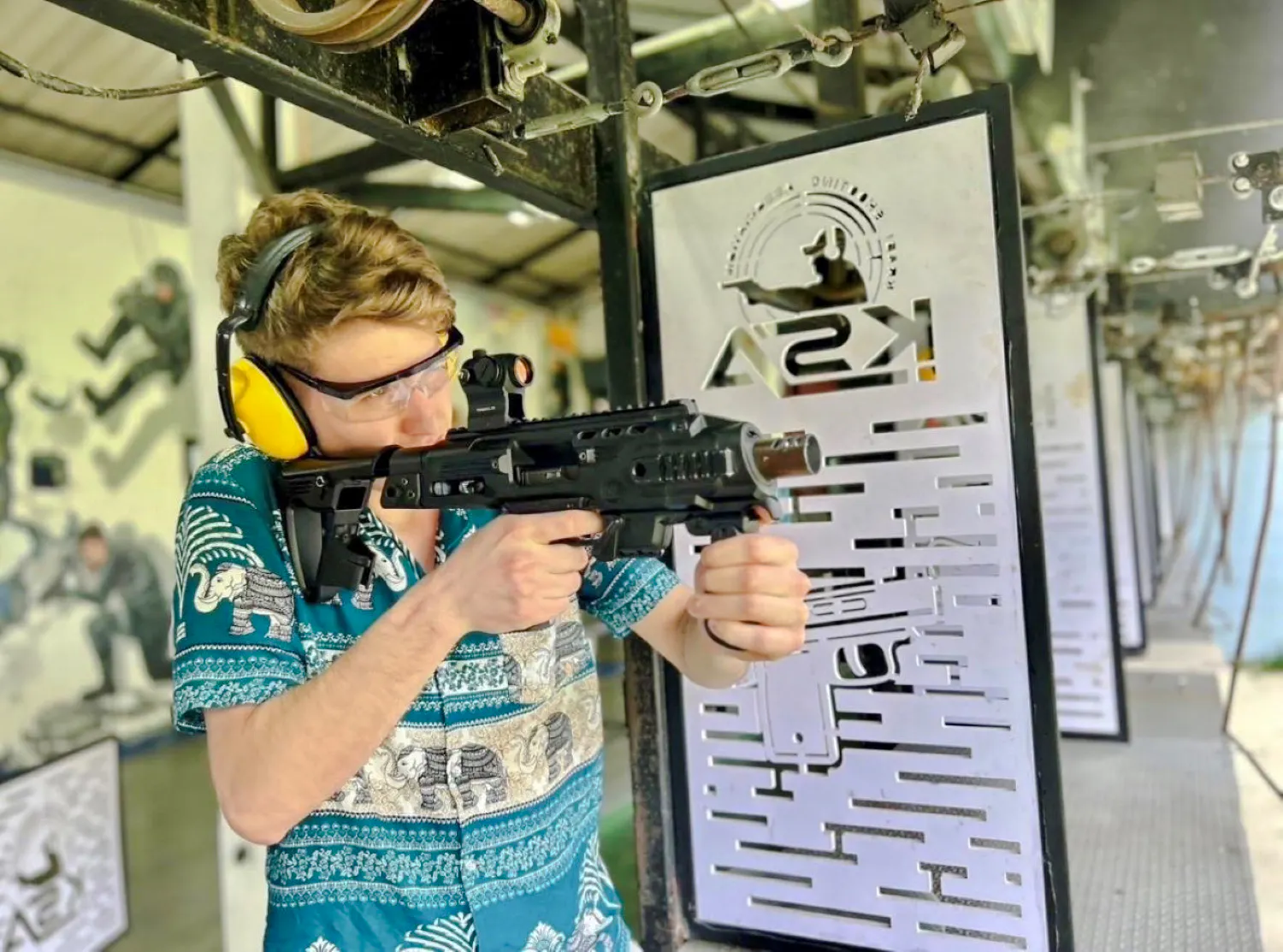 Participant aiming BB gun at shooting range during Krabi ATV Adventure & BB Gun Shooting Experience.