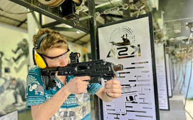 Participant aiming BB gun at shooting range during Krabi ATV Adventure & BB Gun Shooting Experience.