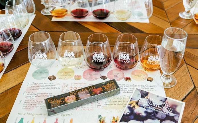 Tulloch Wines tasting set with various wine glasses and a local cheese board menu.