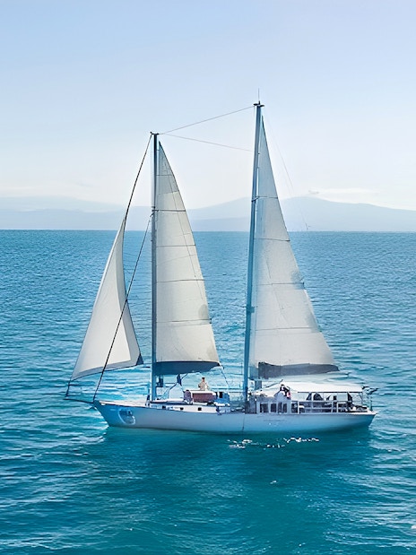Sailing boat on the ocean during Cairns to Great Barrier Reef and Green Island cruise.
