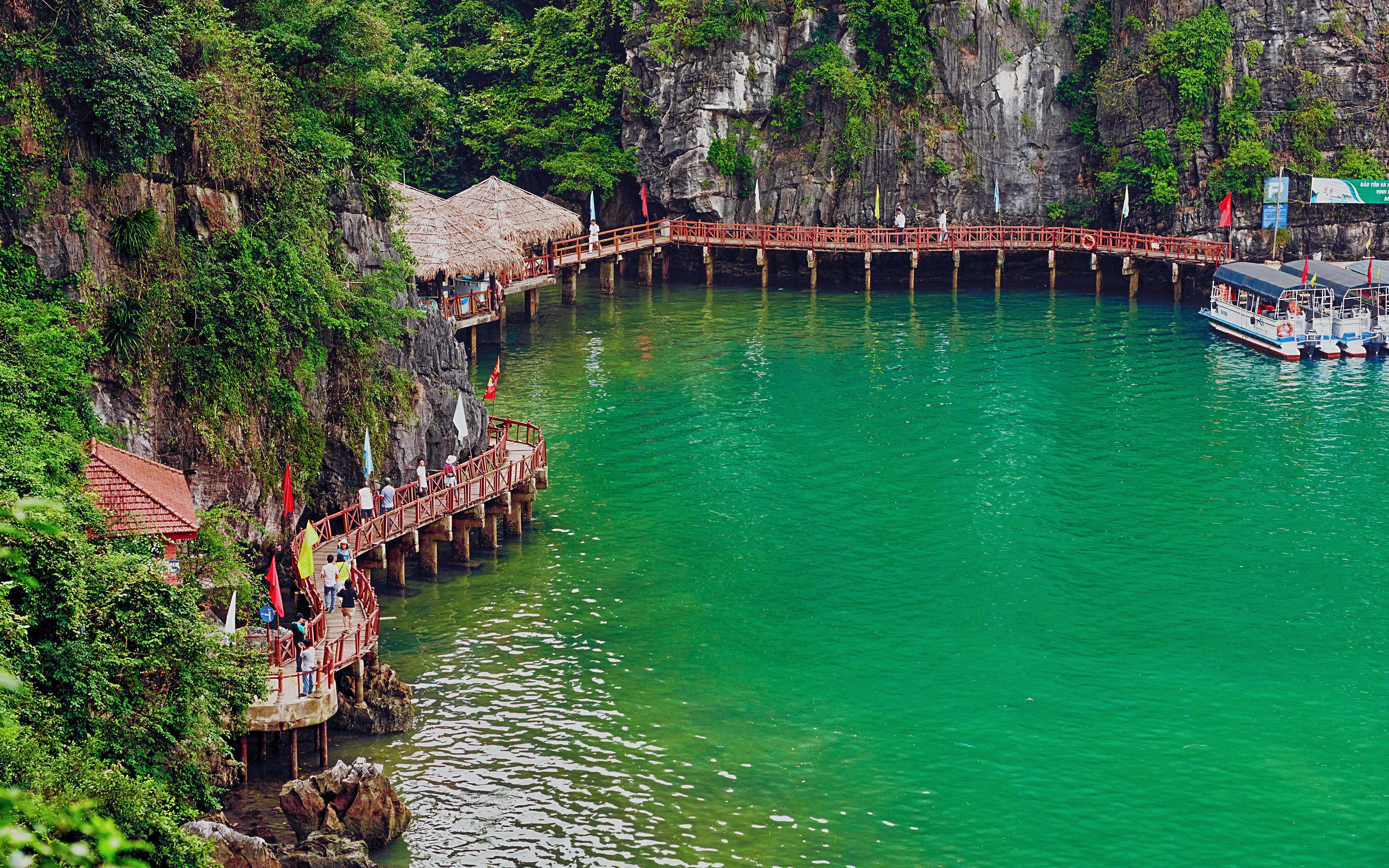 Pier at Hang Sung Sot cave with boats in Ha Long Bay, Vietnam.