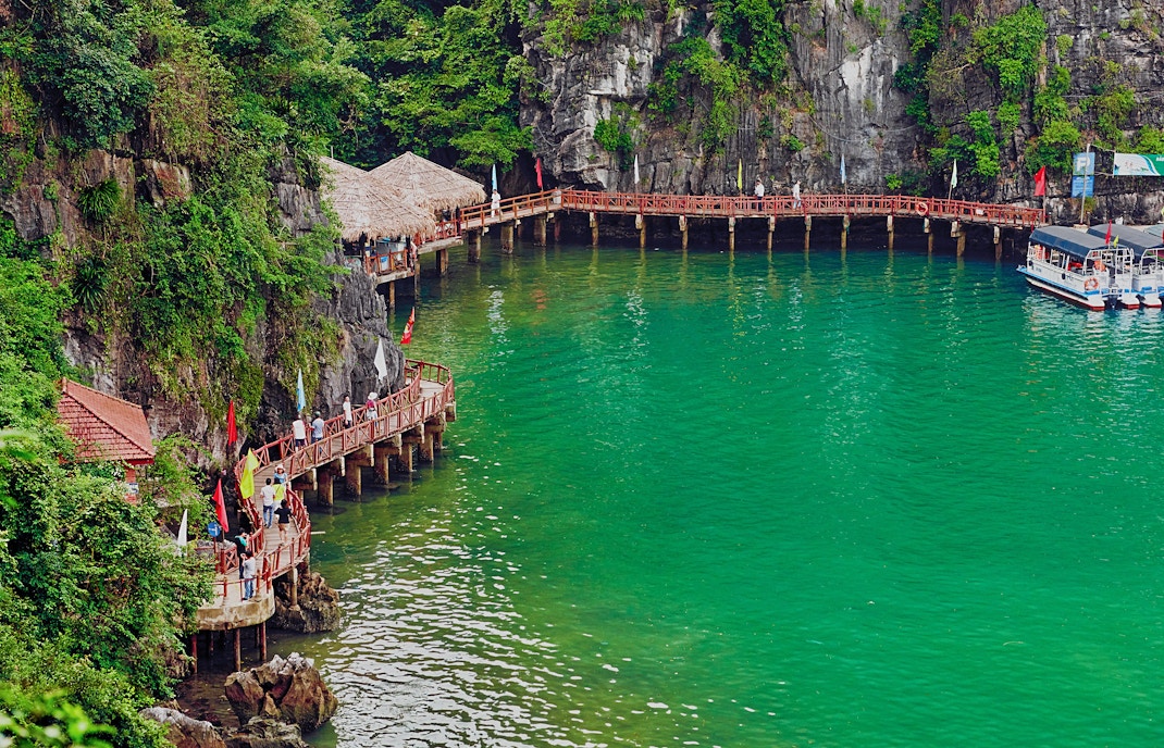 Pier at Hang Sung Sot cave with boats in Ha Long Bay, Vietnam.