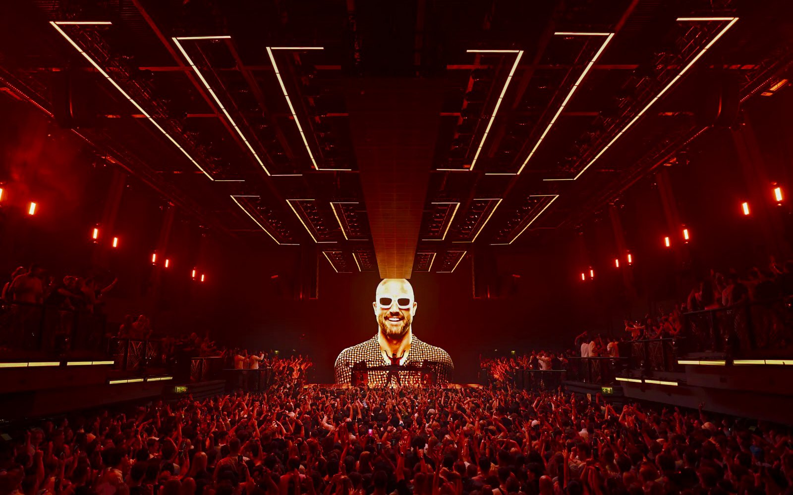 Crowd enjoying Fisher UNVRS performance at a vibrant Ibiza nightclub.