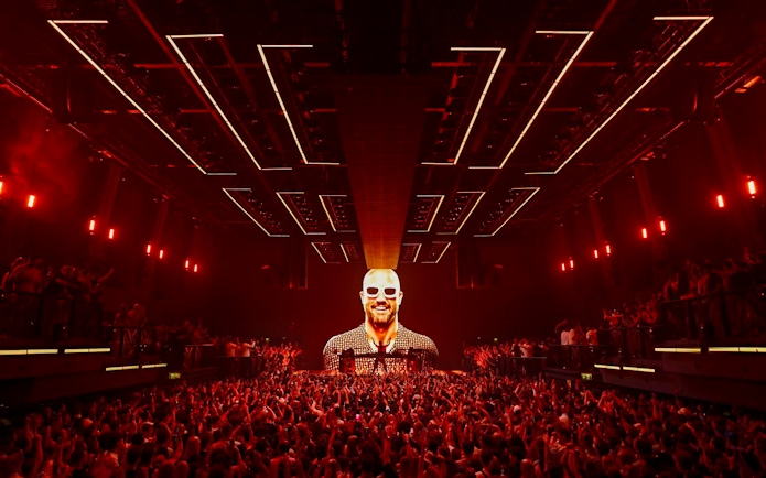 Crowd enjoying Fisher UNVRS performance at a vibrant Ibiza nightclub.