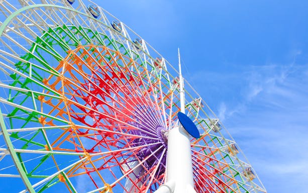 Shining Flower" Ferris wheel at Fuji-Q Highland against blue sky.