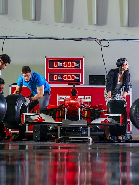Team changing tires on a Formula 1 car at Ferrari World, Yas Island.