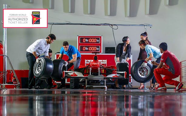 Team changing tires on a Formula 1 car at Ferrari World, Yas Island.