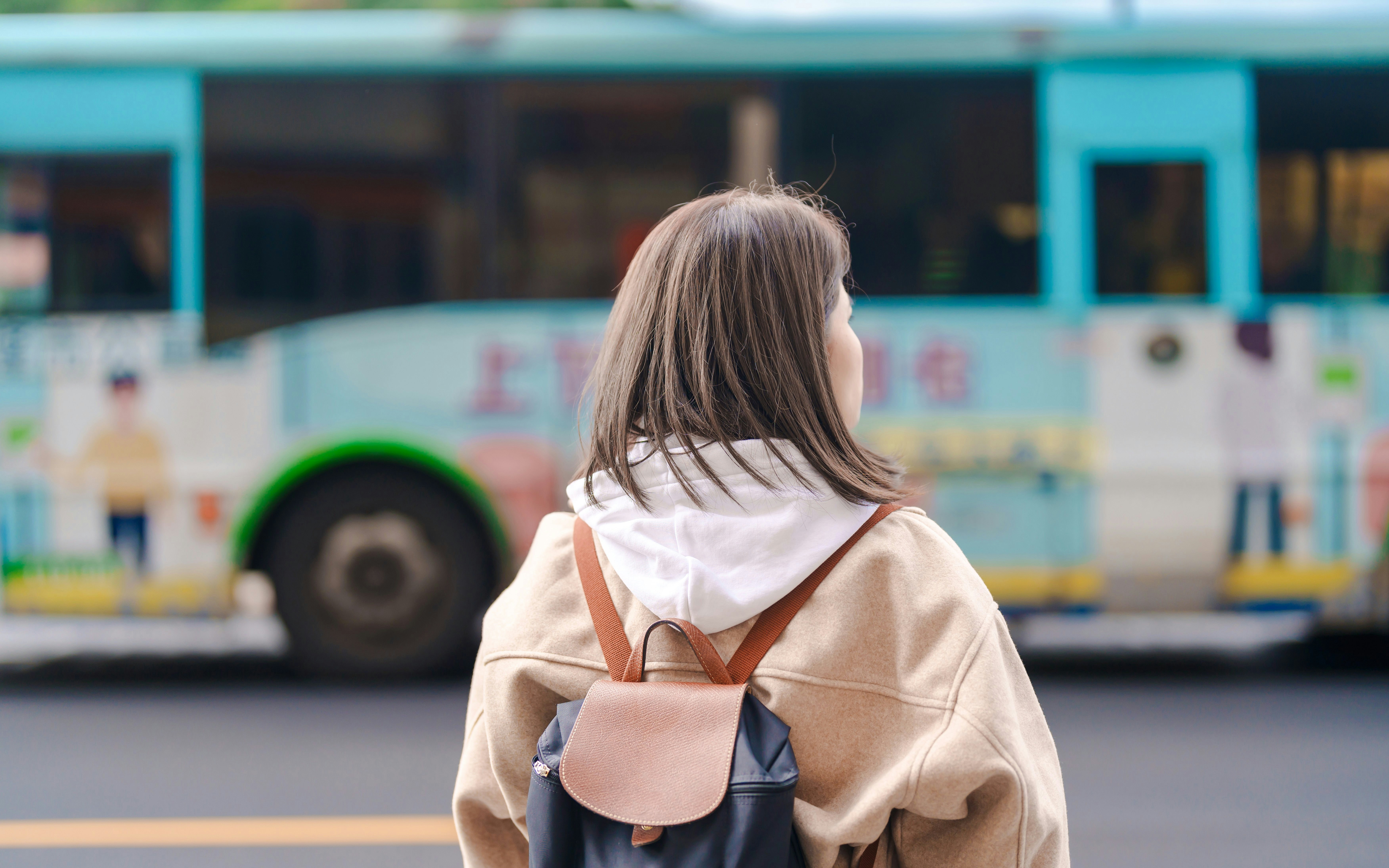 Woman with backpack waiting for bus in Taiwan.