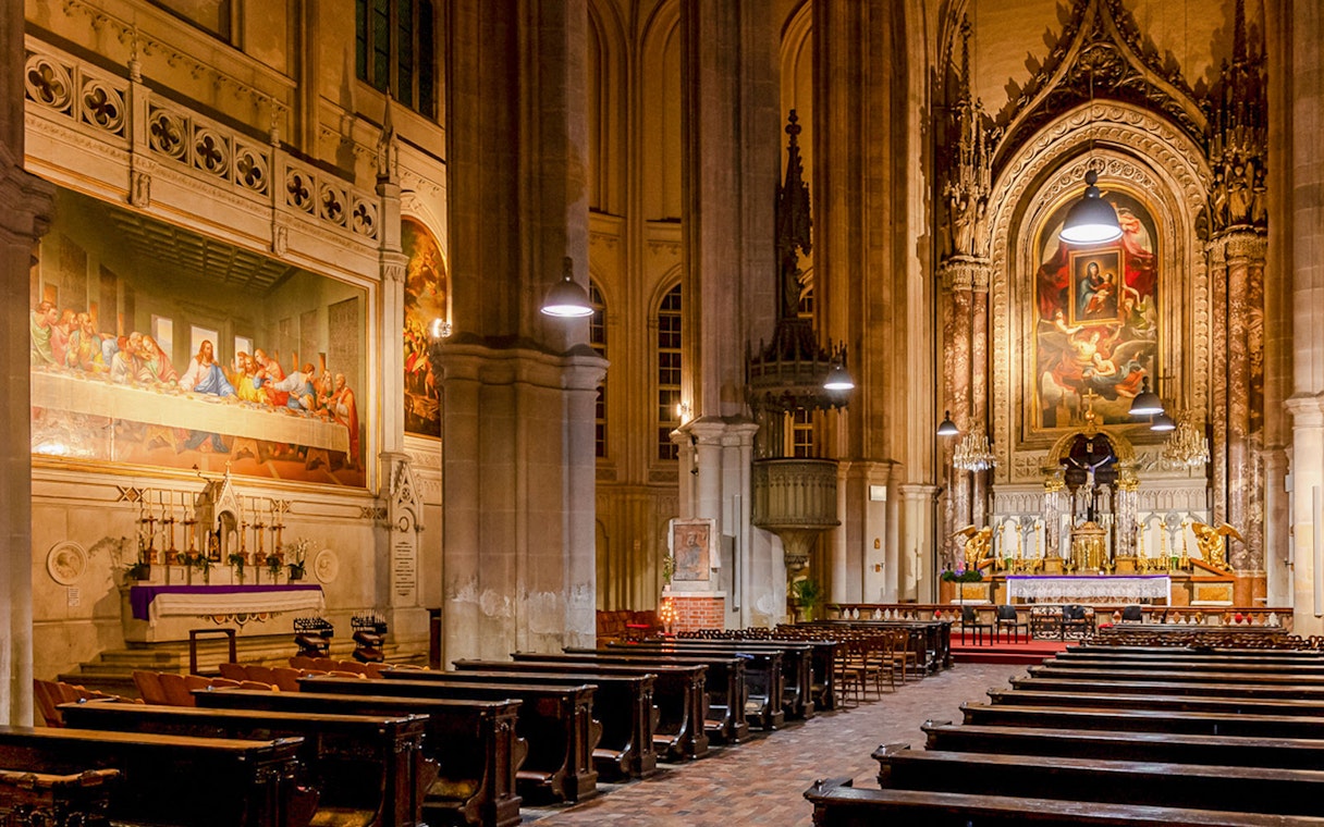 Classical concert setting inside Minoritenkirche, Vienna, with ornate altar and Last Supper mural.