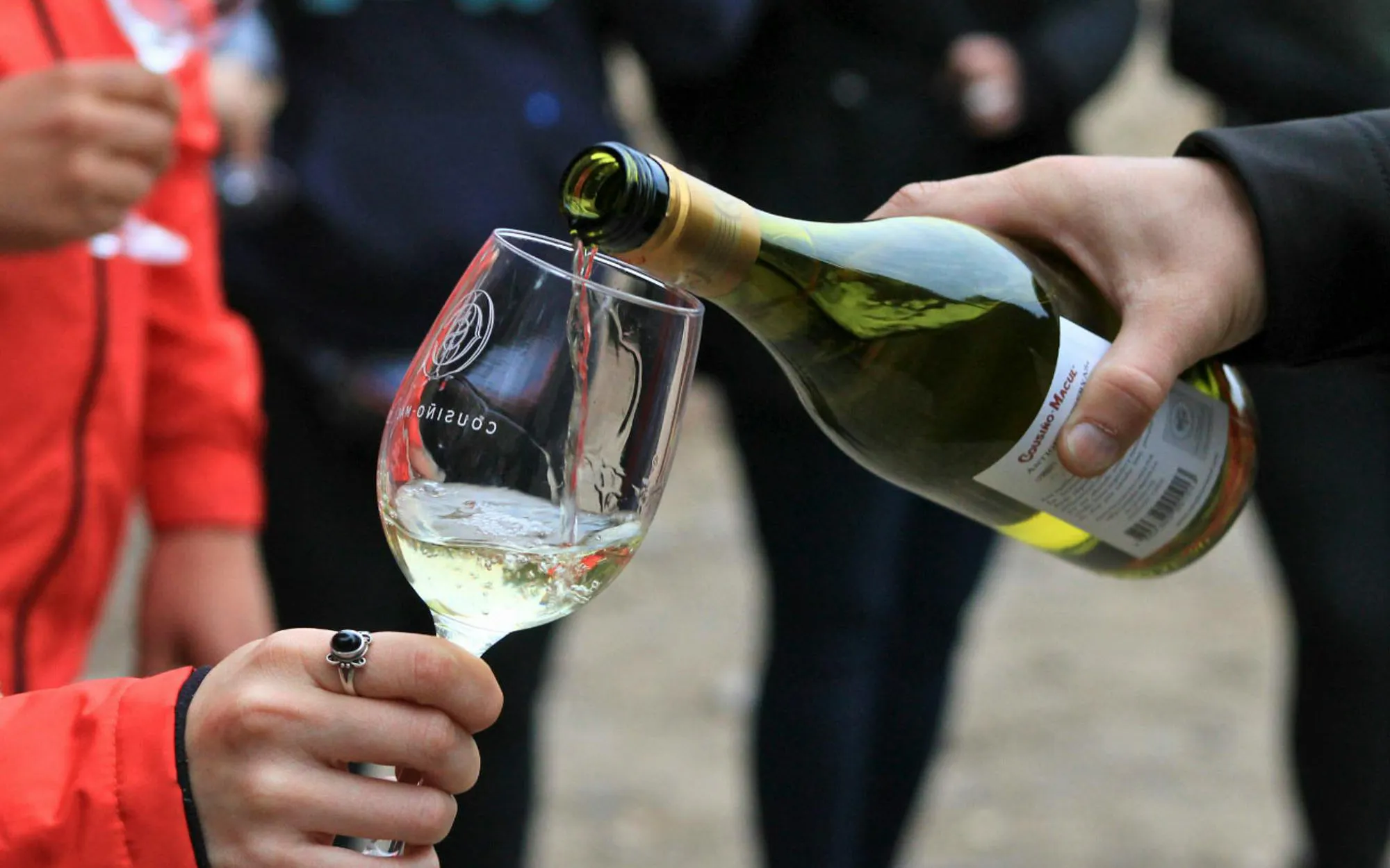 Tourist sampling wine at Cousiño Macul winery.