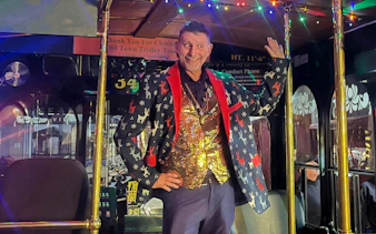 Man in festive attire on Old Town Trolley's Holiday Sights and Festive Nights Tour, San Diego.