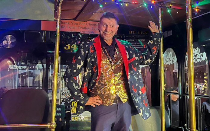 Man in festive attire on Old Town Trolley's Holiday Sights and Festive Nights Tour, San Diego.