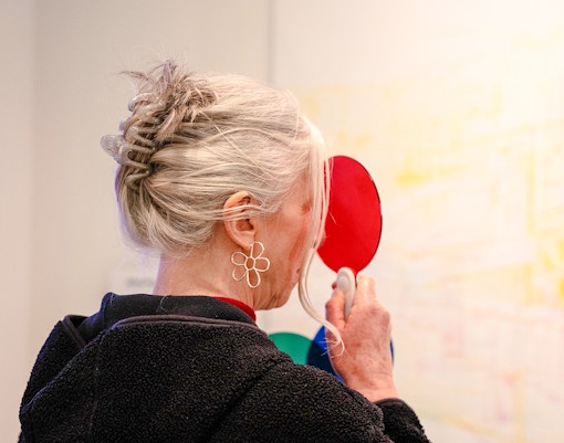 Guest exploring color illusions at World Of Illusions exhibit.