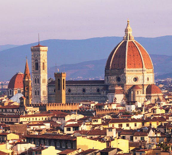 Florence skyline featuring the Duomo and Giotto's Campanile at sunset.
