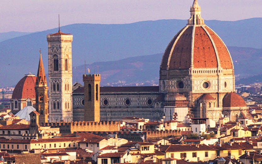 Florence skyline featuring the Duomo and Giotto's Campanile at sunset.