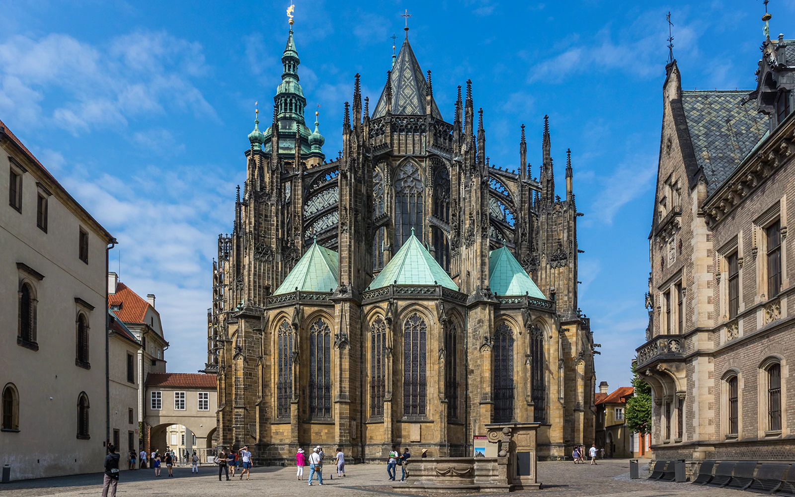 St. Vitus Cathedral in Prague with tourists in the courtyard.