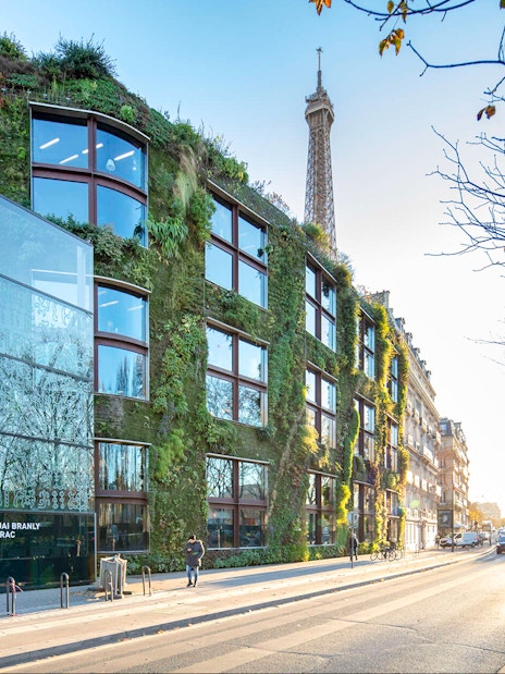 Musee du Quai Branly exterior with vertical garden and Eiffel Tower in background, Paris.