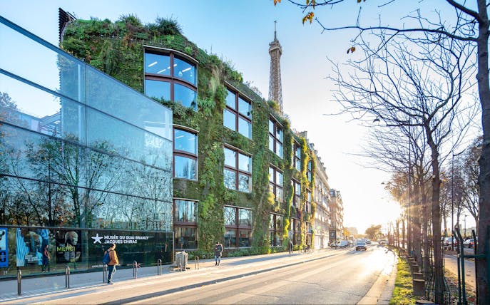 Musee du Quai Branly exterior with vertical garden and Eiffel Tower in background, Paris.