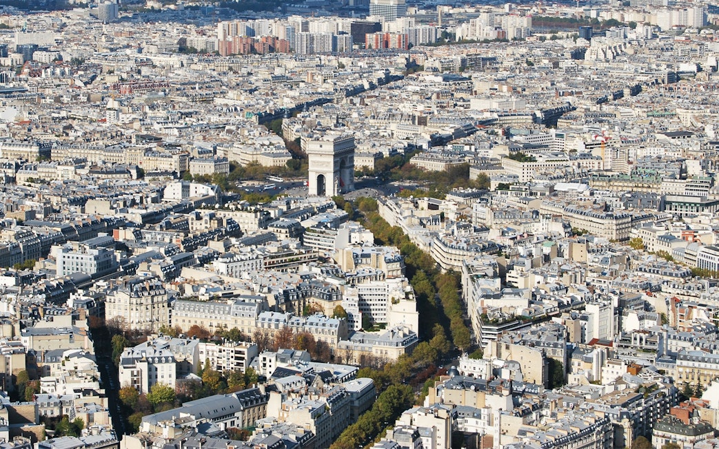 Arc de Triomphe seen from Eiffel Tower, Paris cityscape in view.