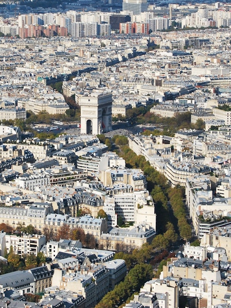Arc de Triomphe seen from Eiffel Tower, Paris cityscape in view.