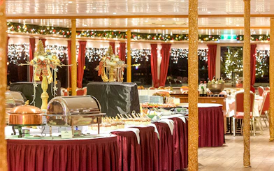Festive dining setup on Advent Afternoon Cruise in Mainz with decorated tables and buffet.
