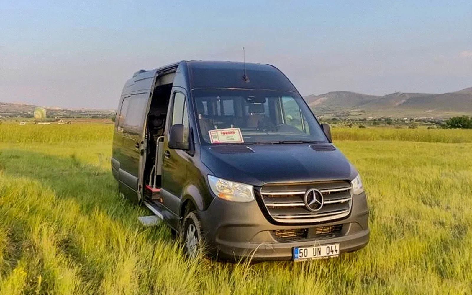 Private tour vehicle in a grassy field, Cappadocia.