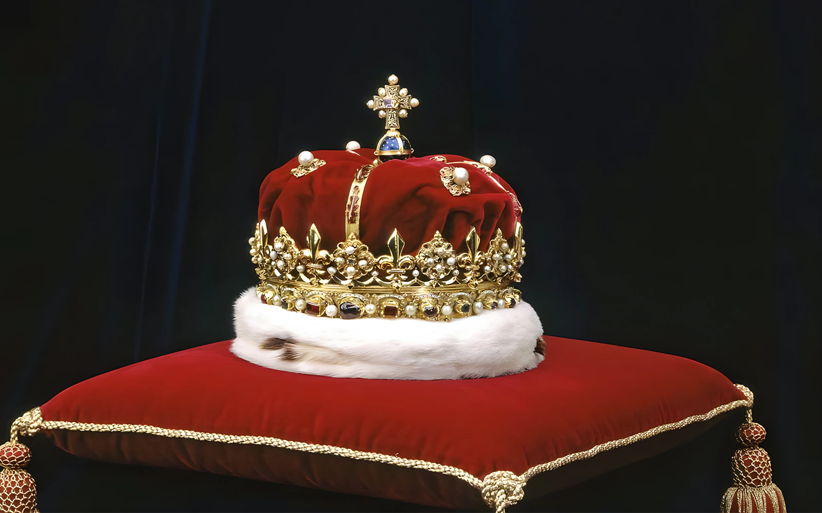Royal crown displayed on a red cushion at Edinburgh Castle.