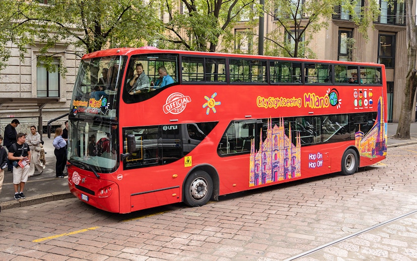 City Sightseeing Milan hop-on hop-off bus at a passenger stop.